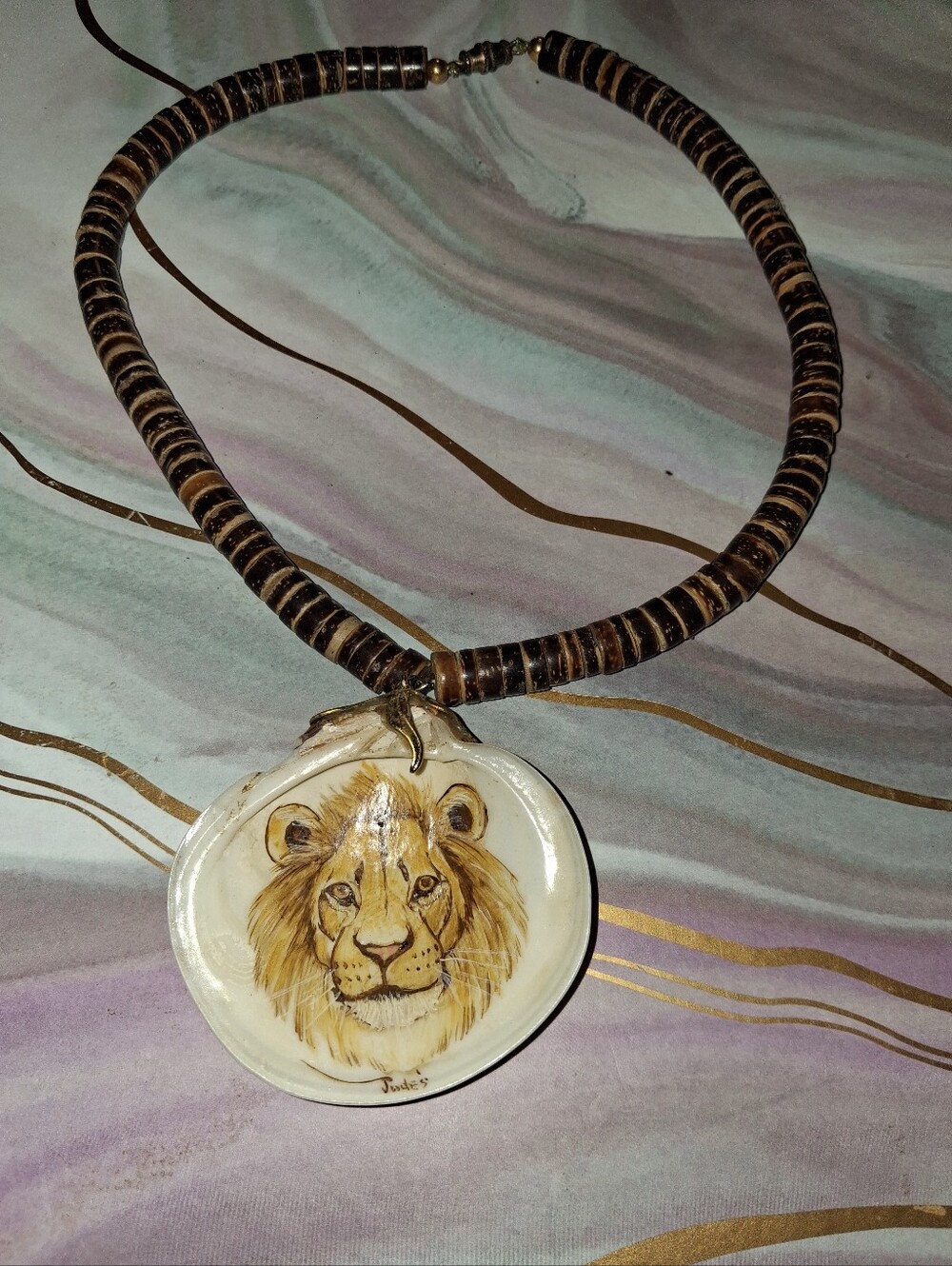FANTASTIC HANDPAINTED LION HEAD PENDANT ON SHELL. 2 BY 2.5.